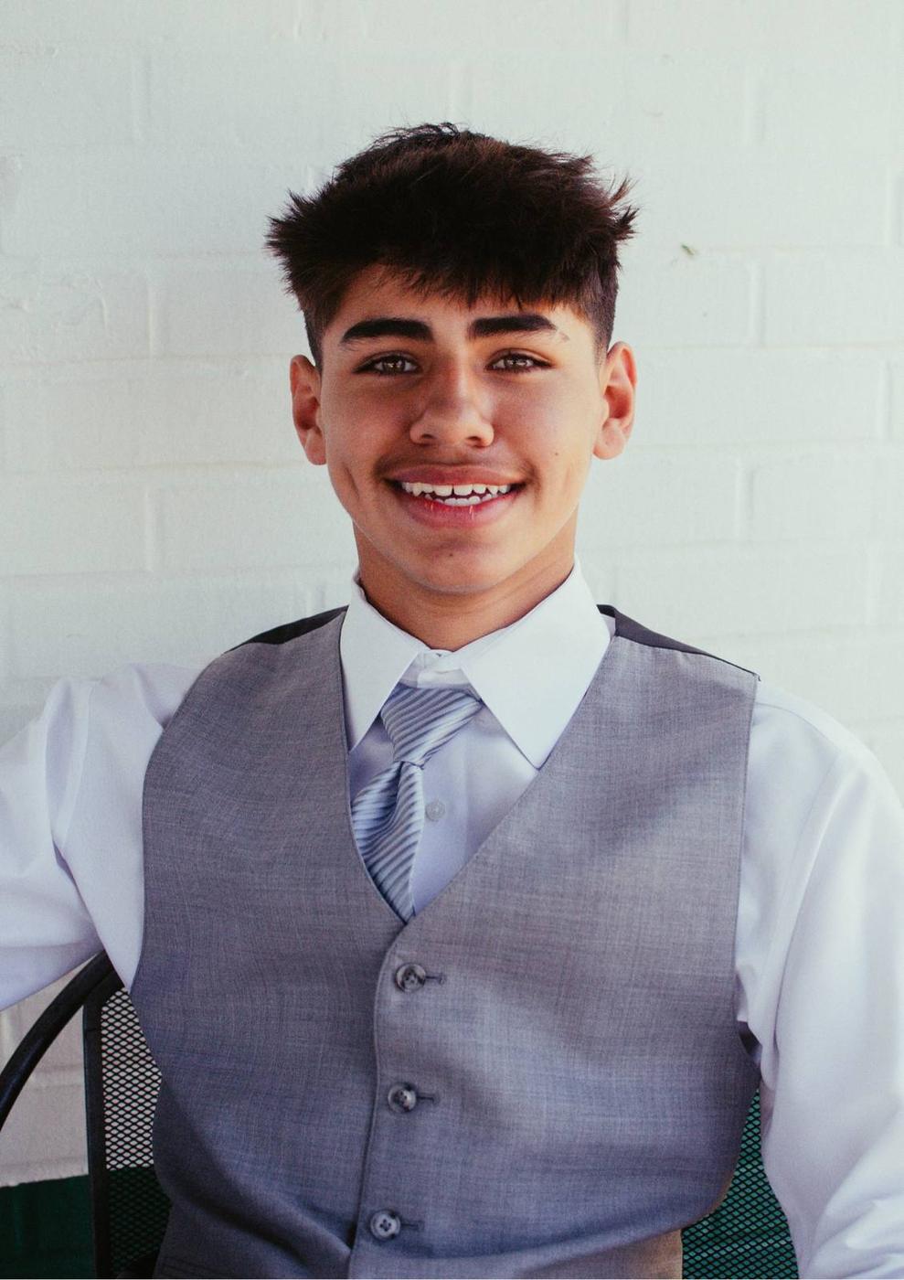 A polished professional portrait in a gray suit