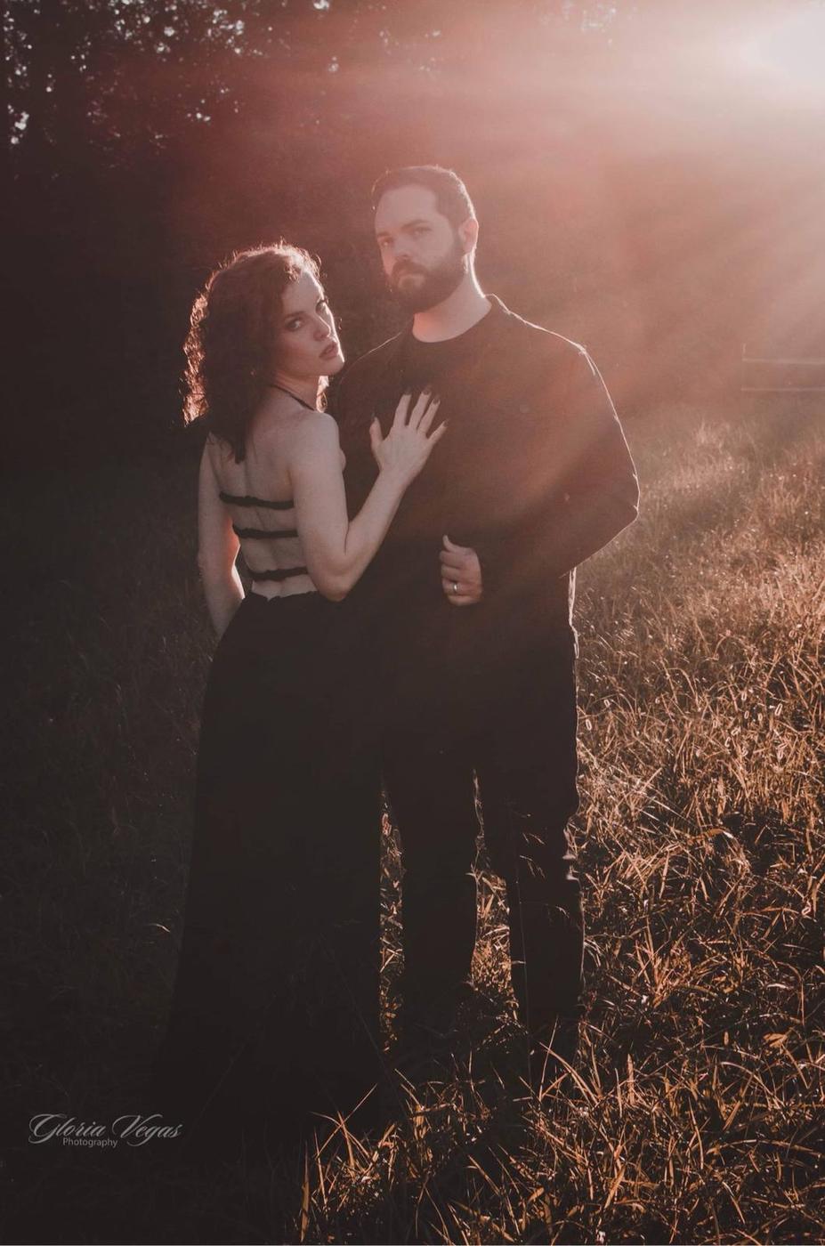 A couple embracing in a sunlit field