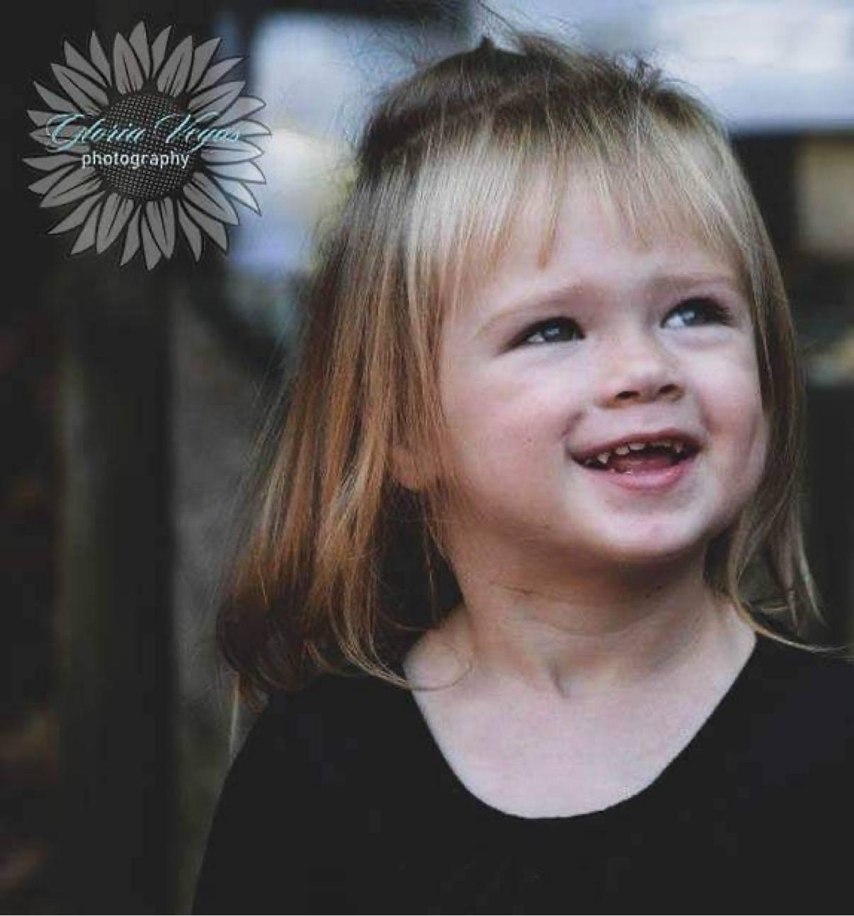 A candid close portrait of a smiling young child