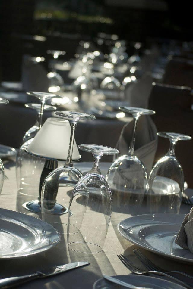 Sunlight sparkling across glassware at a wedding reception table
